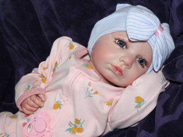 Weighted reborn baby doll with blue eyes and soft cloth body, therapy doll designed for comfort, realism, and relaxation